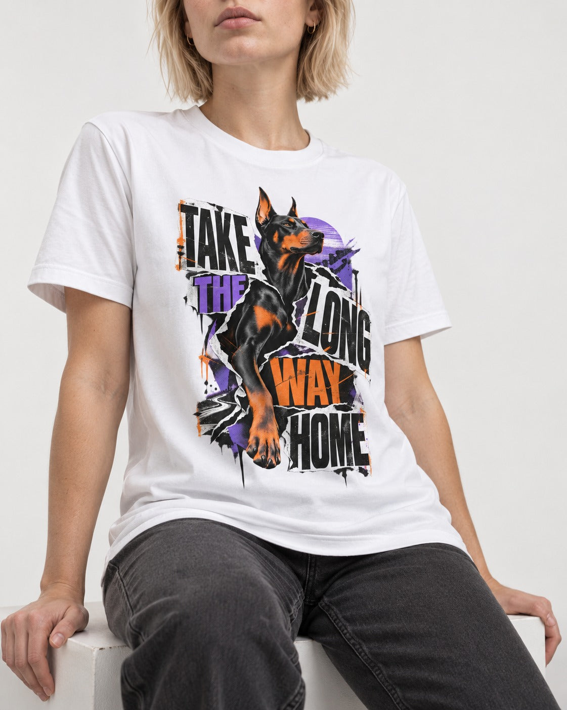 Doberman Long Way Home T-Shirt in White, worn by a seated model