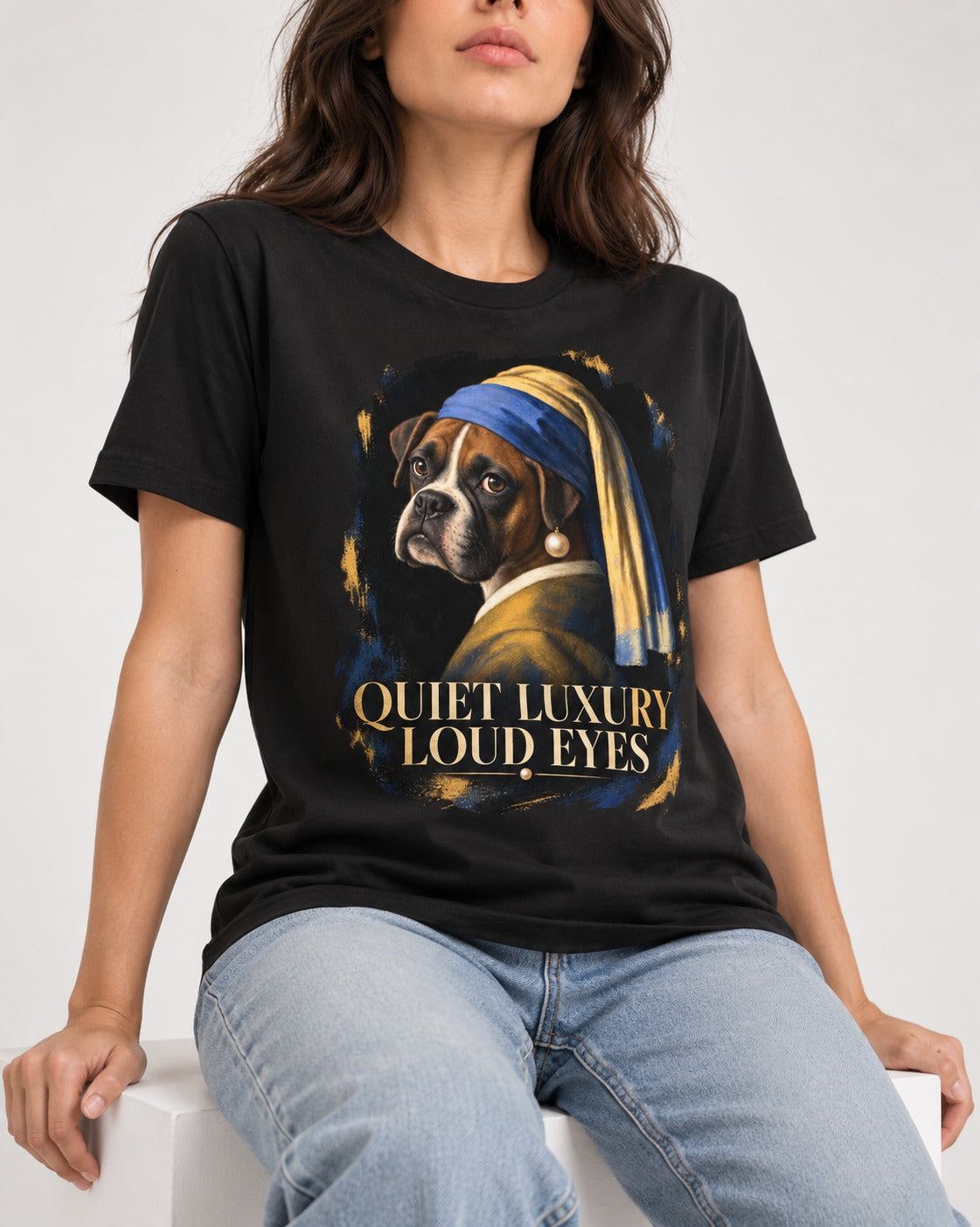 Quiet Luxury Loud Eyes Boxer Pearl Portrait T-Shirt in Black, worn by a seated model