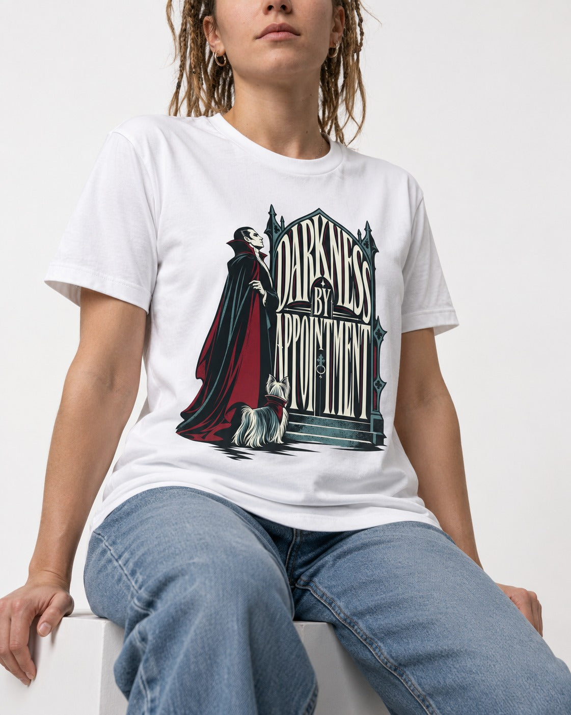 Darkness by Appointment with Yorkshire Terrier T-Shirt in White, worn by a seated model