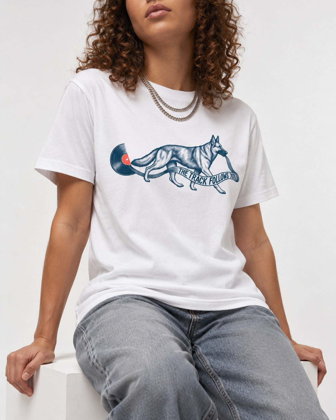 German Shepherd Dog The Track Follows You T-Shirt in White, worn by a seated model
