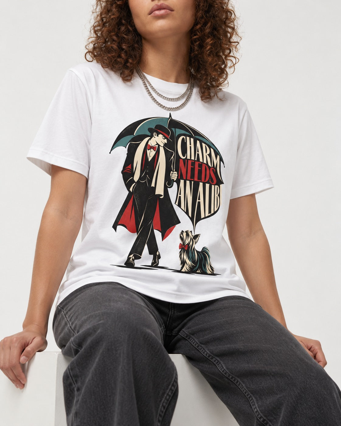 Charm Needs an Alibi Yorkshire Terrier T-Shirt in White, worn by a seated model