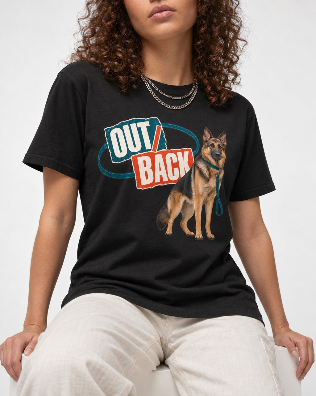 Out Back Leash German Shepherd Dog Graphic T-Shirt in Black, worn by a seated model