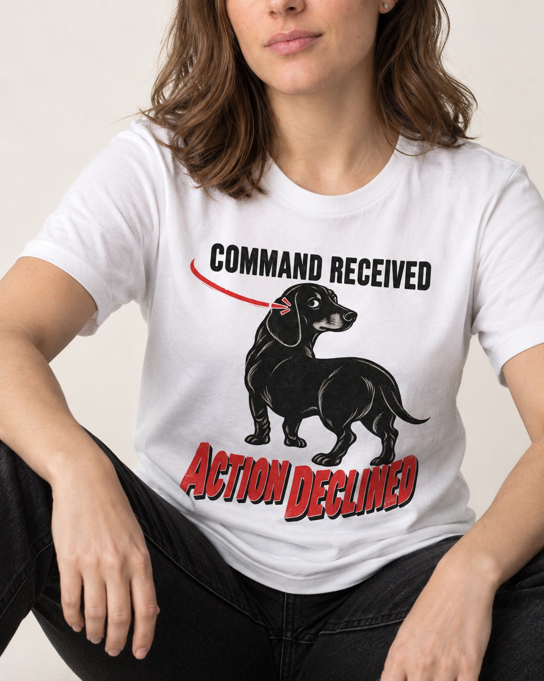 Dachshund Action Declined T-Shirt in White, worn by a seated model