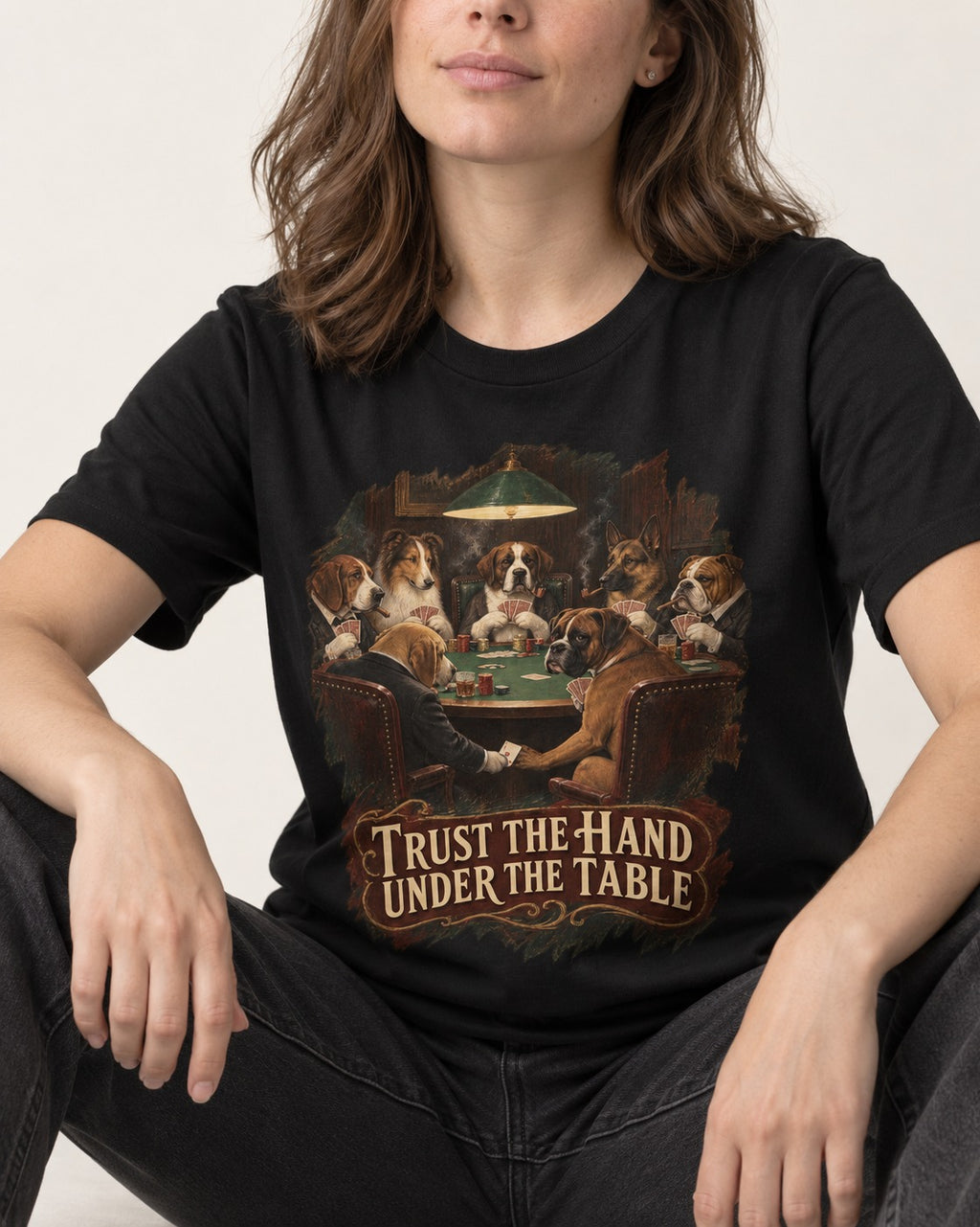 Trust the Hand Under the Table Boxer Poker Graphic T-Shirt in Black, worn by a seated model