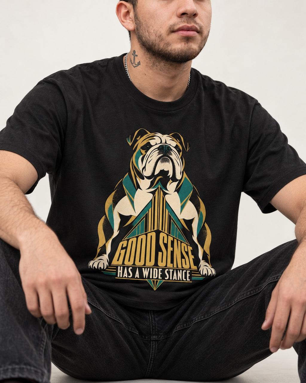 Good Sense Has a Wide Stance English Bulldog Graphic T-Shirt in Black, worn by a seated model