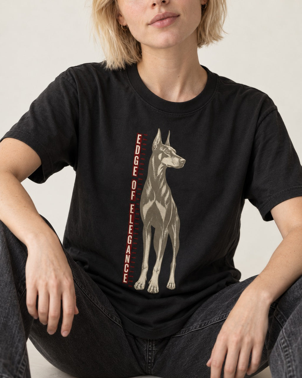 Doberman Edge of Elegance Height Chart Graphic T-Shirt in Black, worn by a seated model