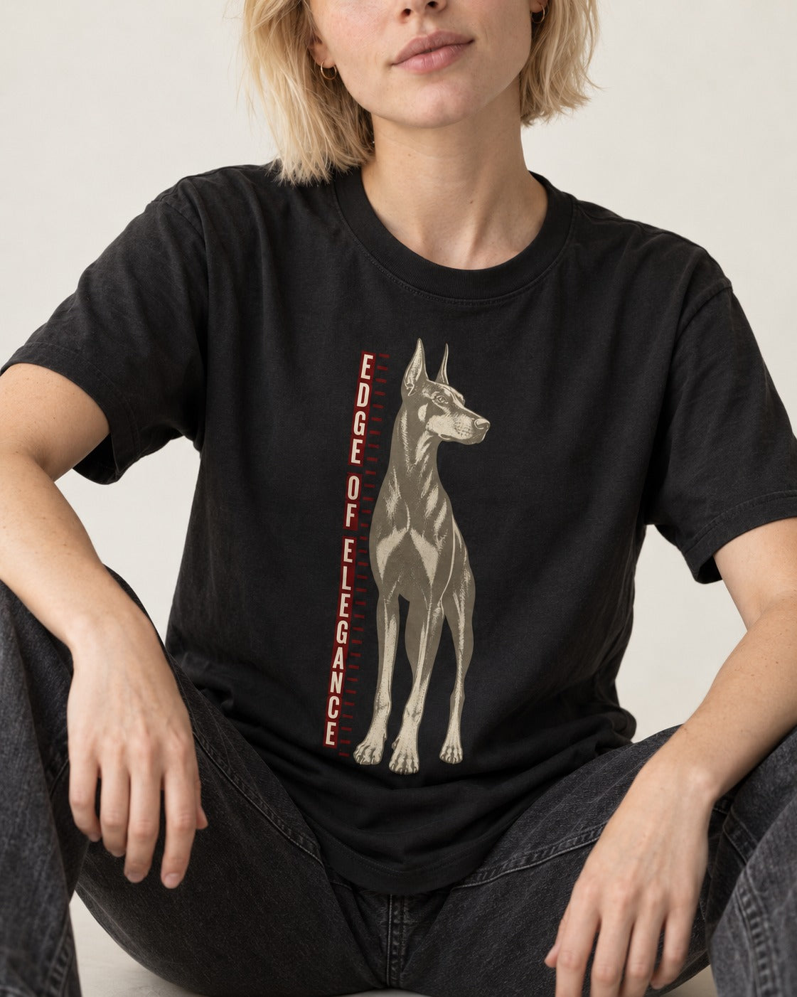 Doberman Edge of Elegance Height Chart Graphic T-Shirt in Black, worn by a seated model