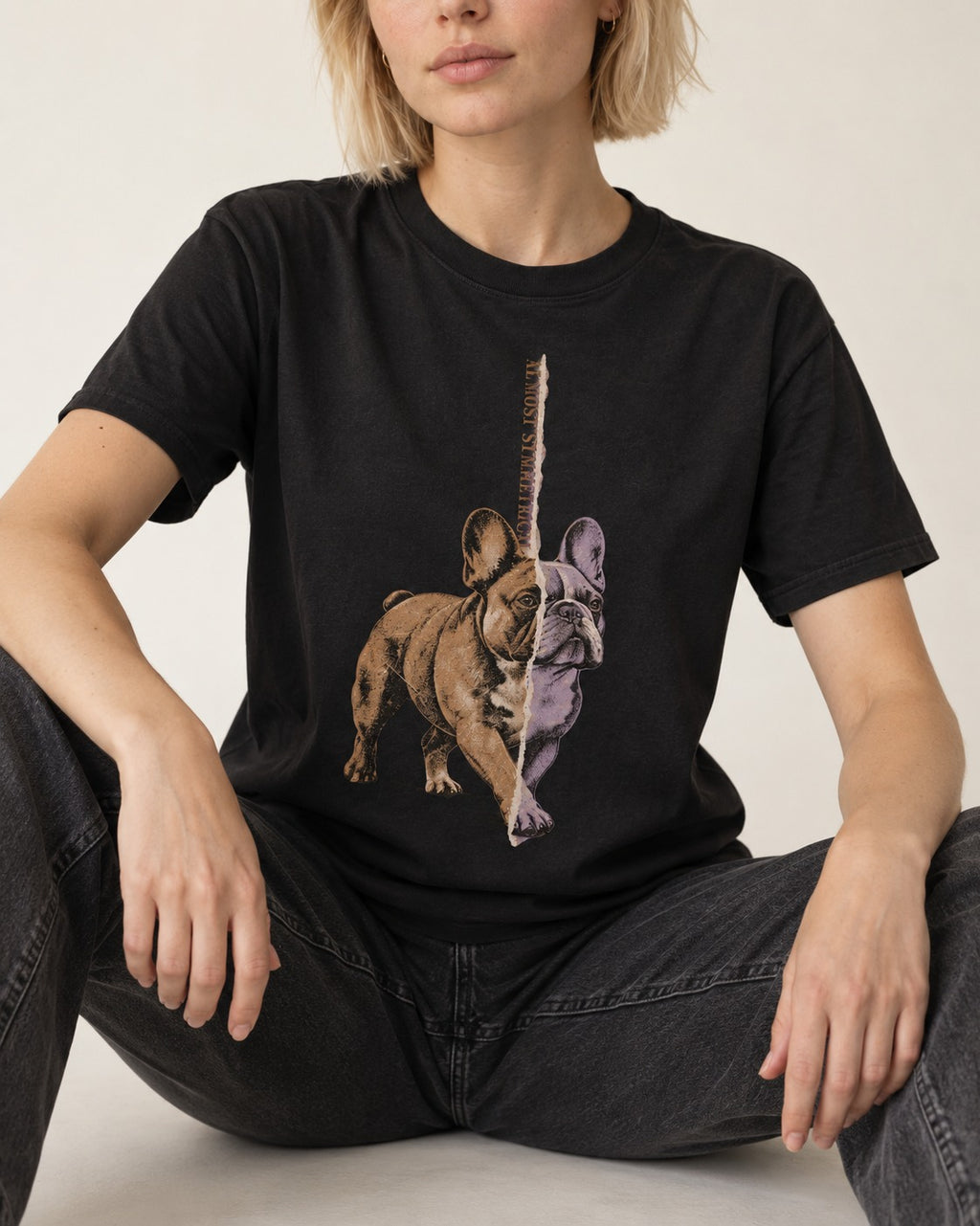 Frenchie Almost Symmetrical Torn Split Graphic T-Shirt in Black, worn by a seated model