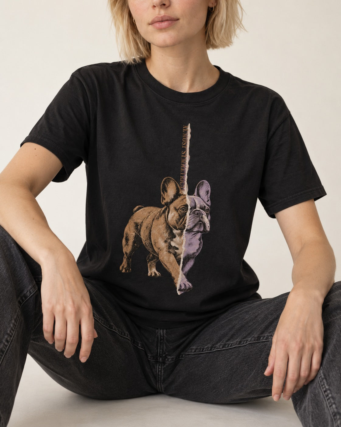 Frenchie Almost Symmetrical Torn Split Graphic T-Shirt in Black, worn by a seated model