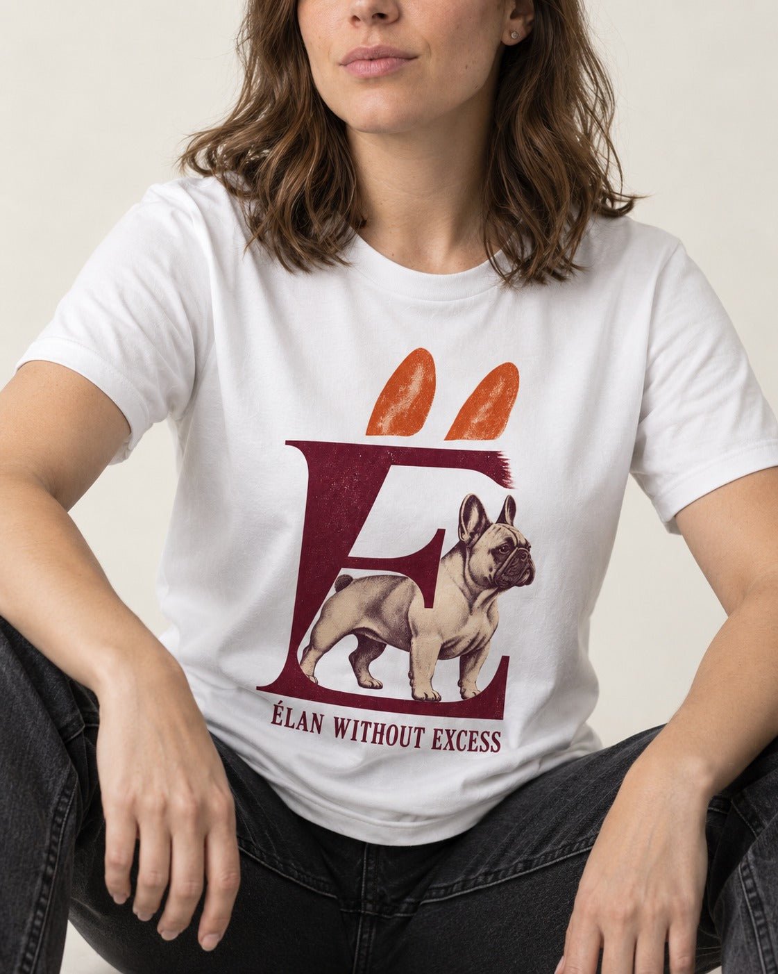 Frenchie Without Excess T-Shirt in White, worn by a seated model