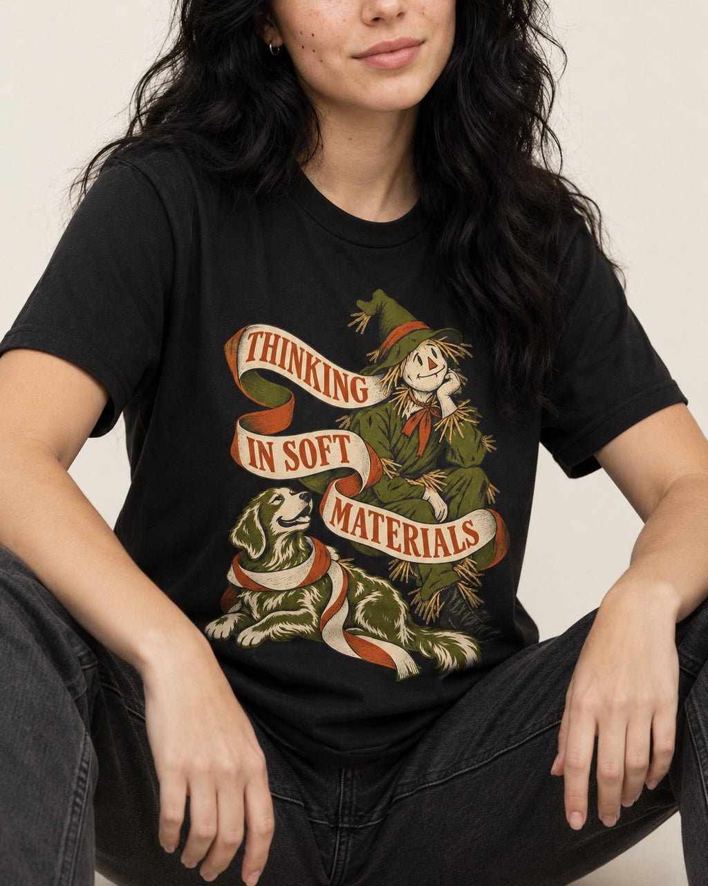 Golden Retriever Thinking in Soft Materials Scarecrow Graphic T-Shirt in Black, worn by a seated model