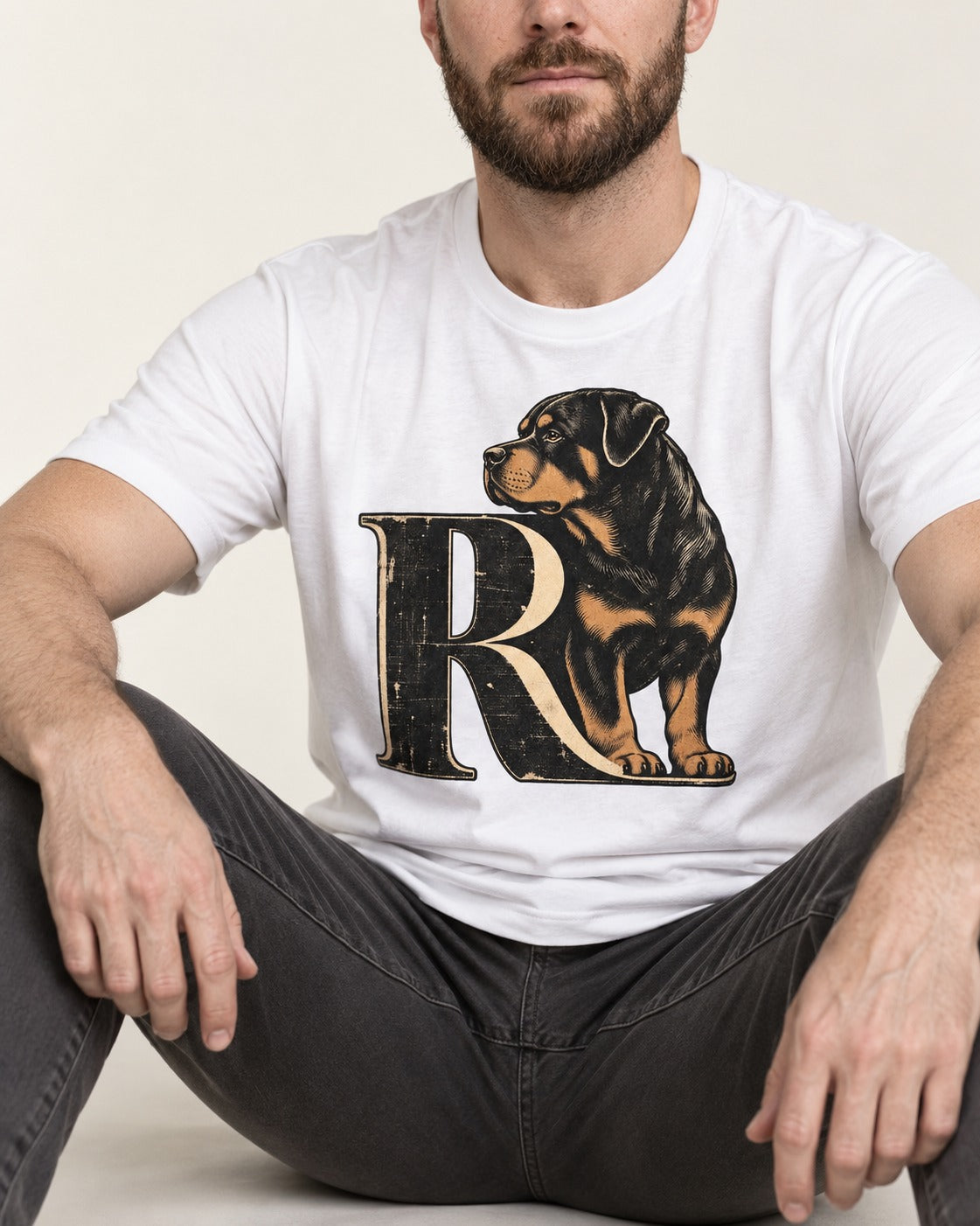Rottweiler Pride T-Shirt in White, worn by a seated model
