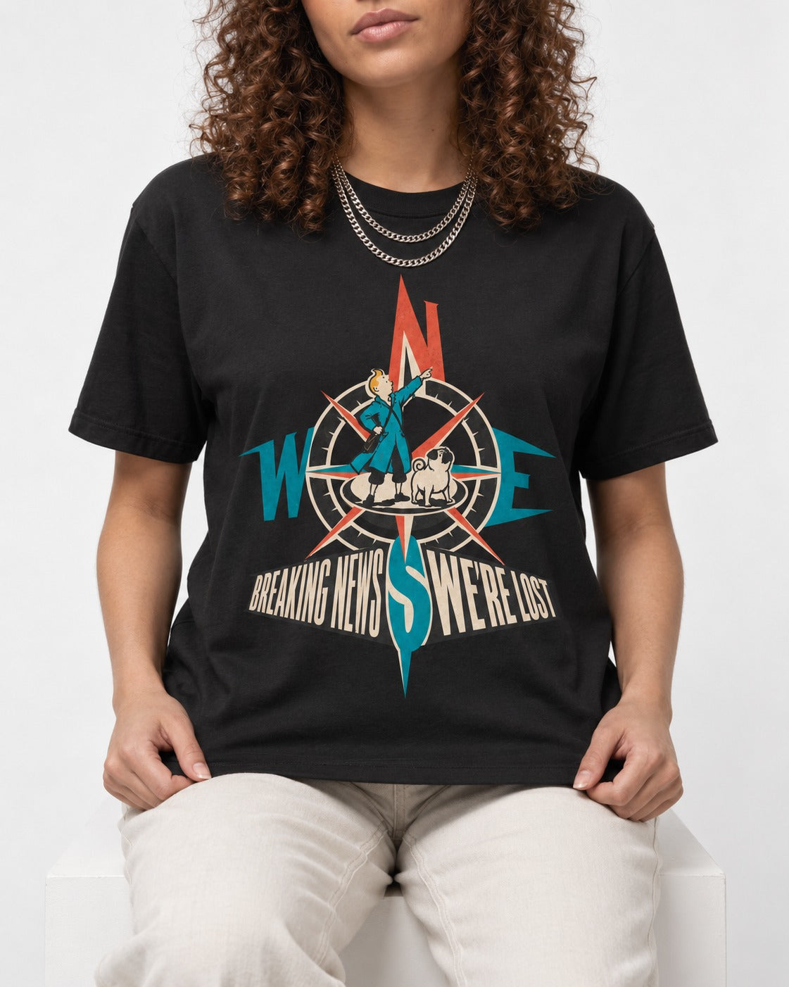 Pug Breaking News We're Lost Compass Graphic T-Shirt in Black, worn by a seated model