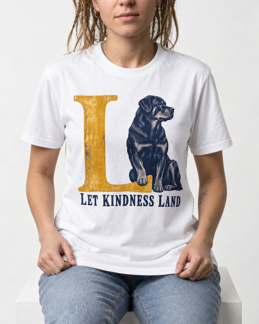 Let Kindness Lead Rottweiler T-Shirt in White, worn by a seated model