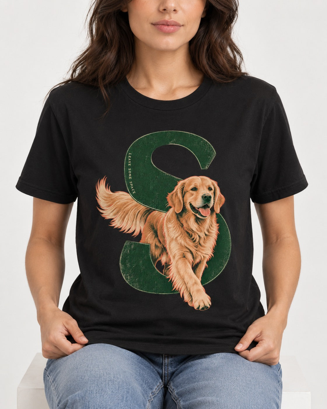Golden Retriever Leave Some Space Monogram Graphic T-Shirt in Black, worn by a seated model
