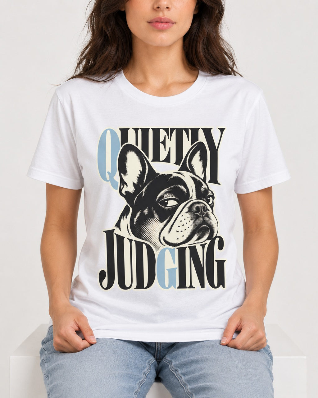 Quietly Judging Frenchie T-Shirt in White, worn by a seated model