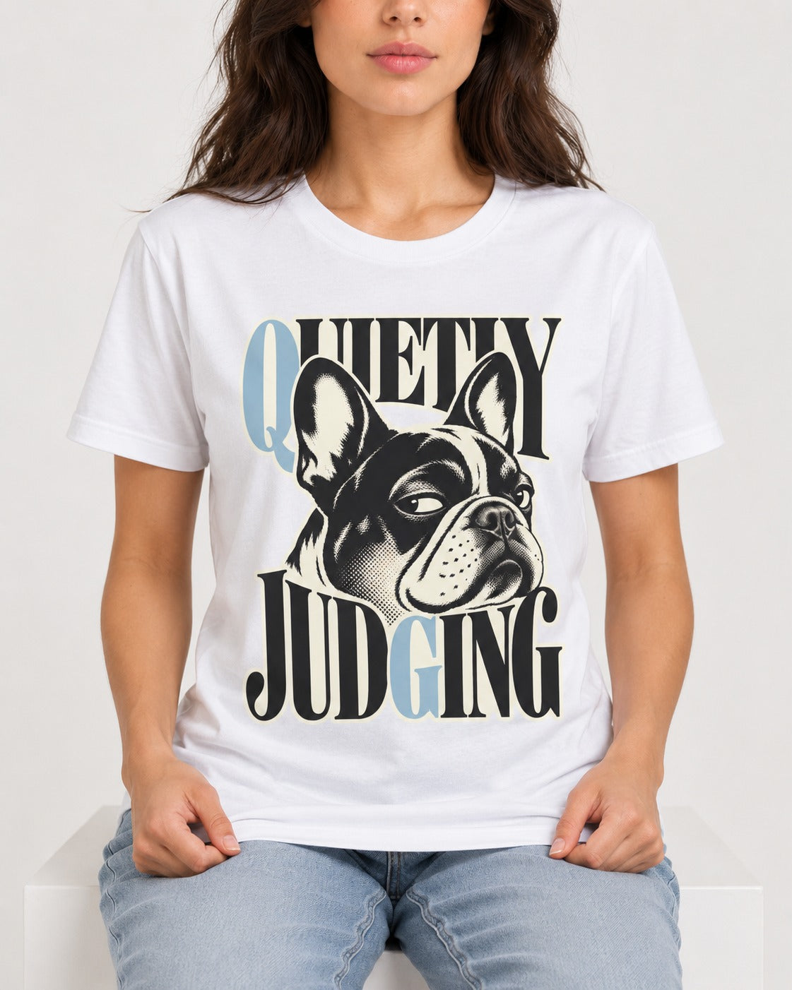 Quietly Judging Frenchie T-Shirt in White, worn by a seated model