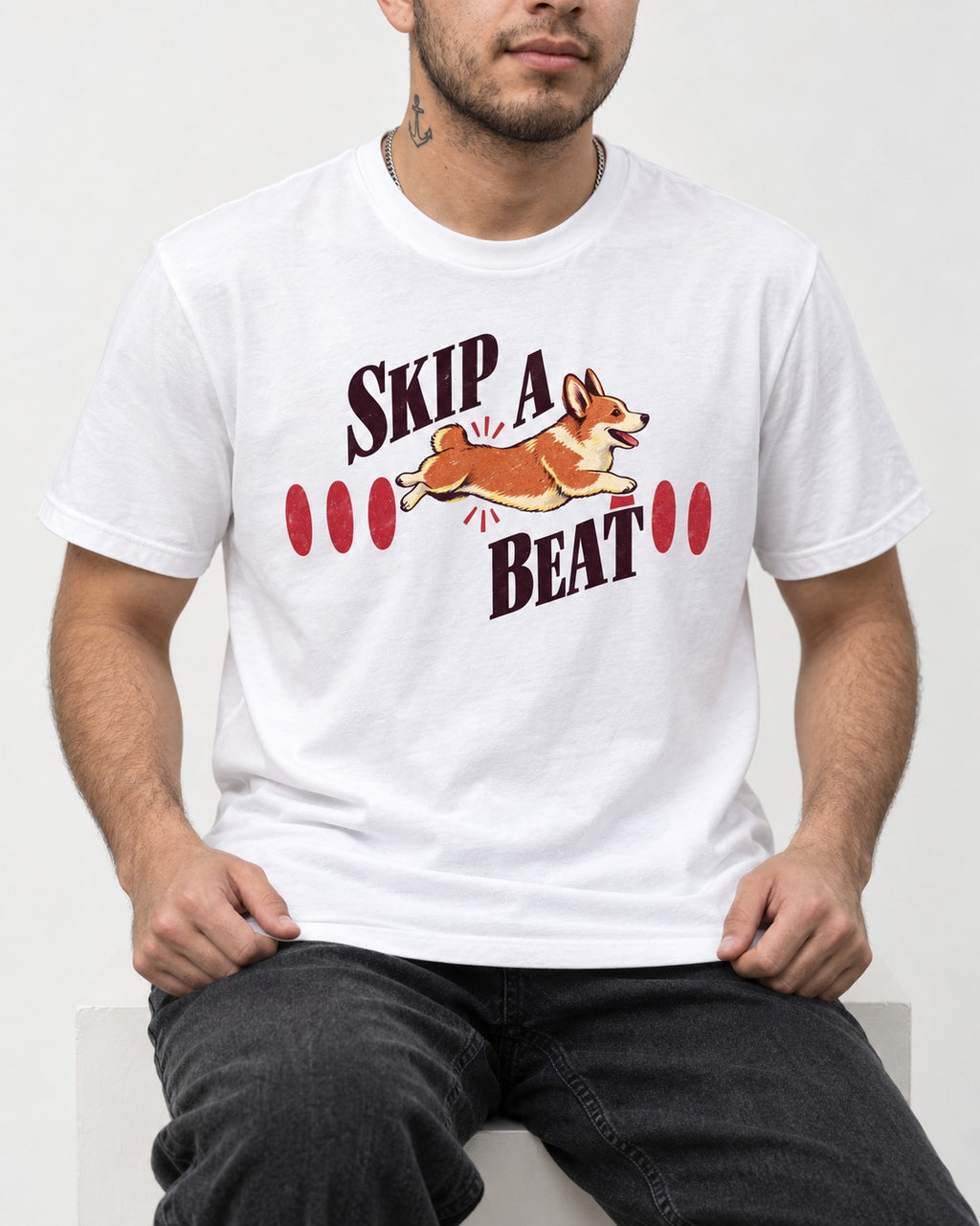 Skip a Beat Corgi T-Shirt in White, worn by a seated model