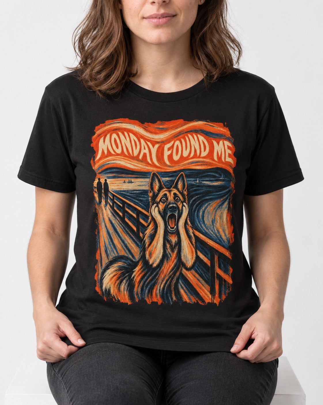 German Shepherd Dog Monday Found Me Scream Graphic T-Shirt in Black, worn by a seated model
