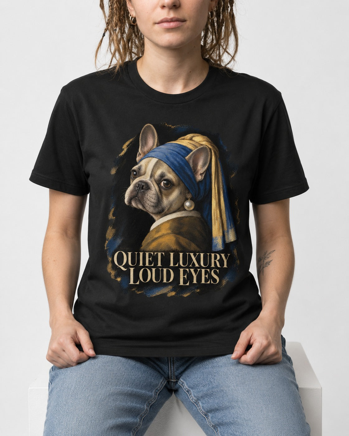 Frenchie Quiet Luxury Loud Eyes Pearl Portrait Graphic T-Shirt in Black, worn by a seated model