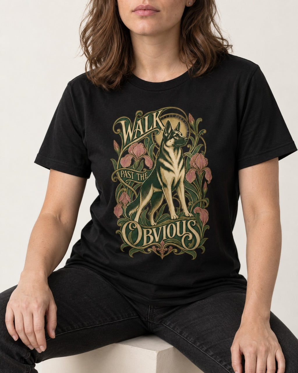 Walk Past The Obvious Art Nouveau German Shepherd Dog Graphic T-Shirt in Black, worn by a seated model