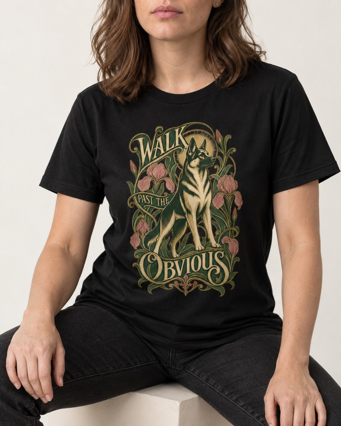 Walk Past The Obvious Art Nouveau German Shepherd Dog Graphic T-Shirt in Black, worn by a seated model