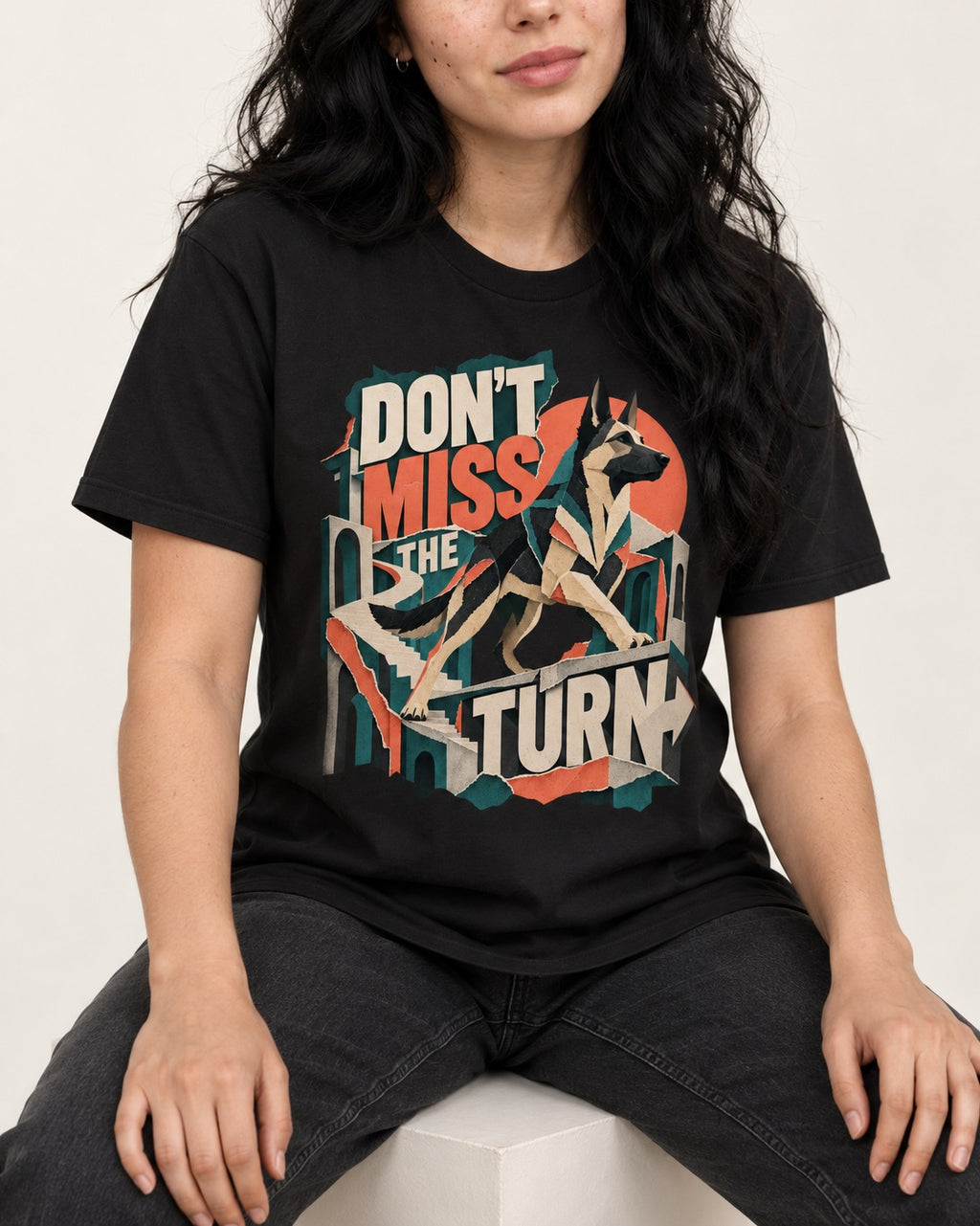 Dont Miss The Turn Escher Staircase German Shepherd Dog Graphic T-Shirt in Black, worn by a seated model