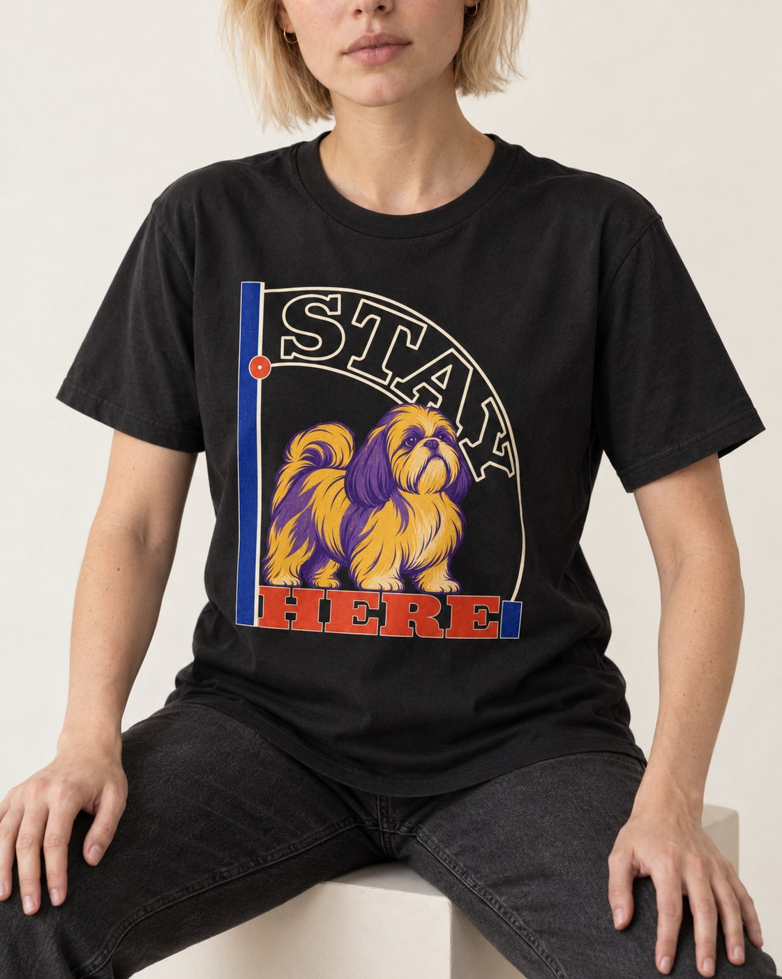 Shih Tzu Stay Here Semicircle Sign Graphic T-Shirt in Black, worn by a seated model