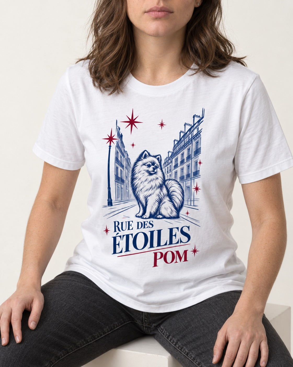 Pomeranian Among the Stars T-Shirt in White, worn by a seated model