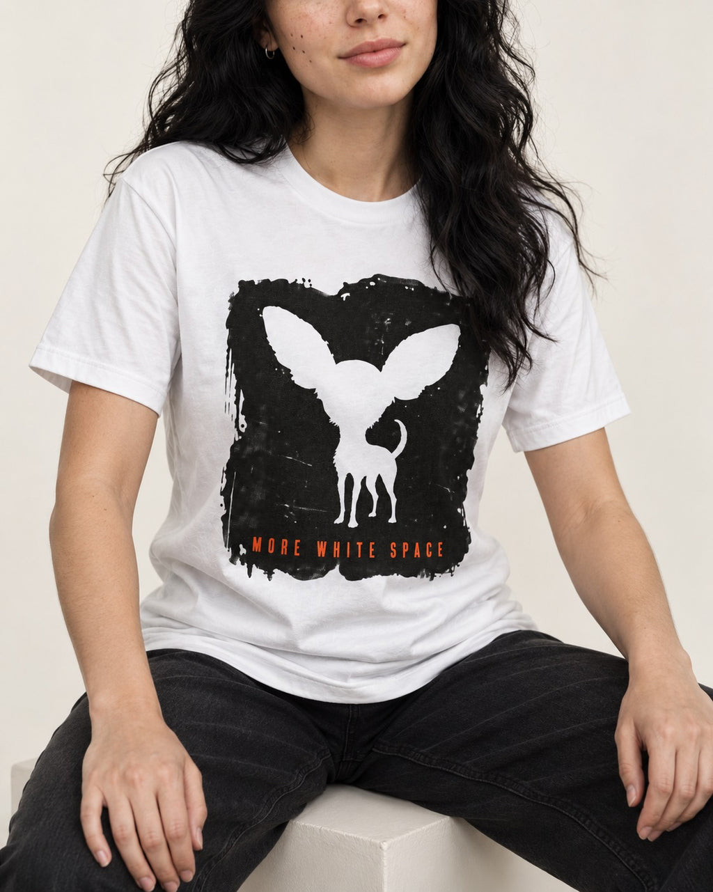 More White Space Chihuahua T-Shirt in White, worn by a seated model