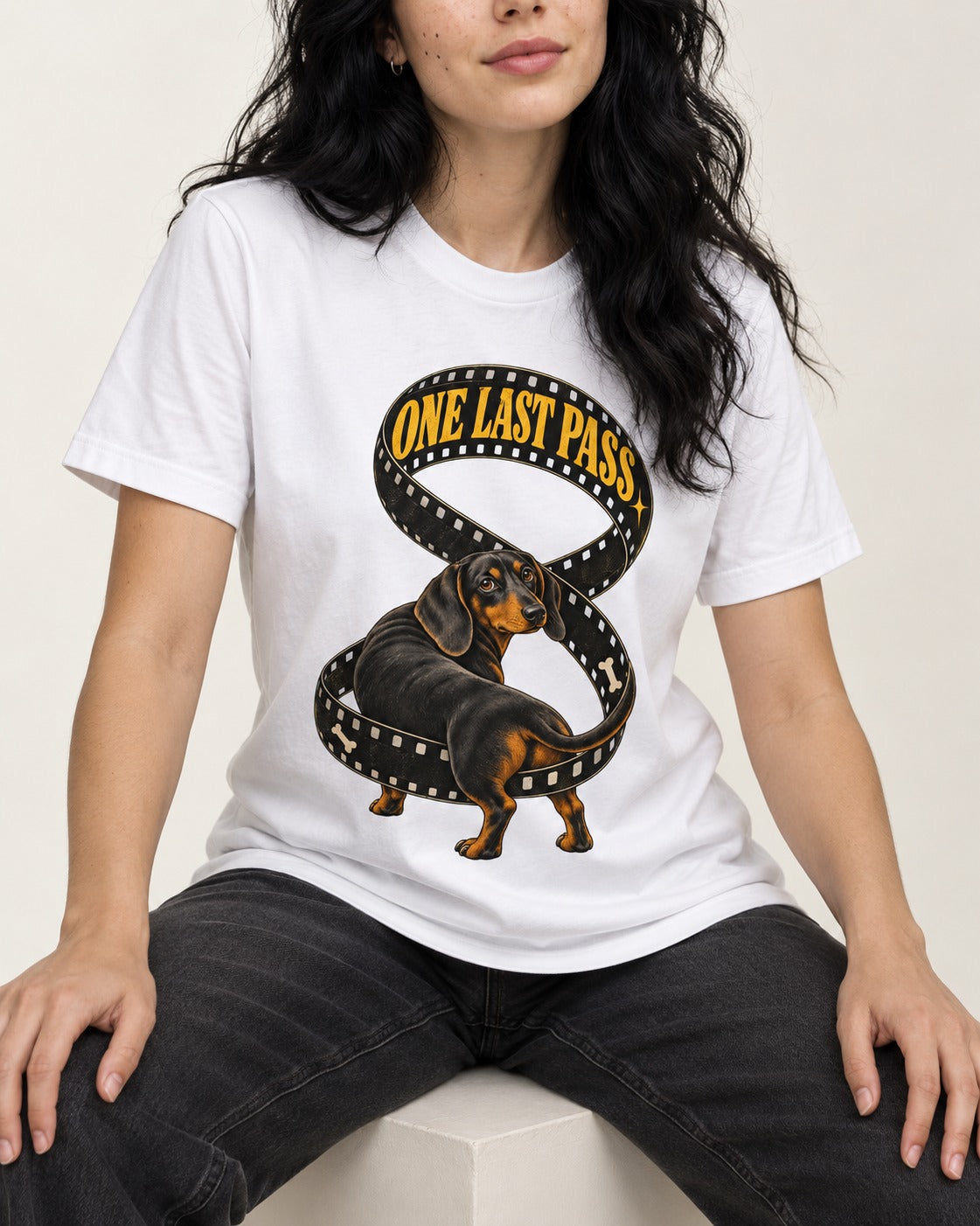 Dachshund's One Last Pass T-Shirt in White, worn by a seated model