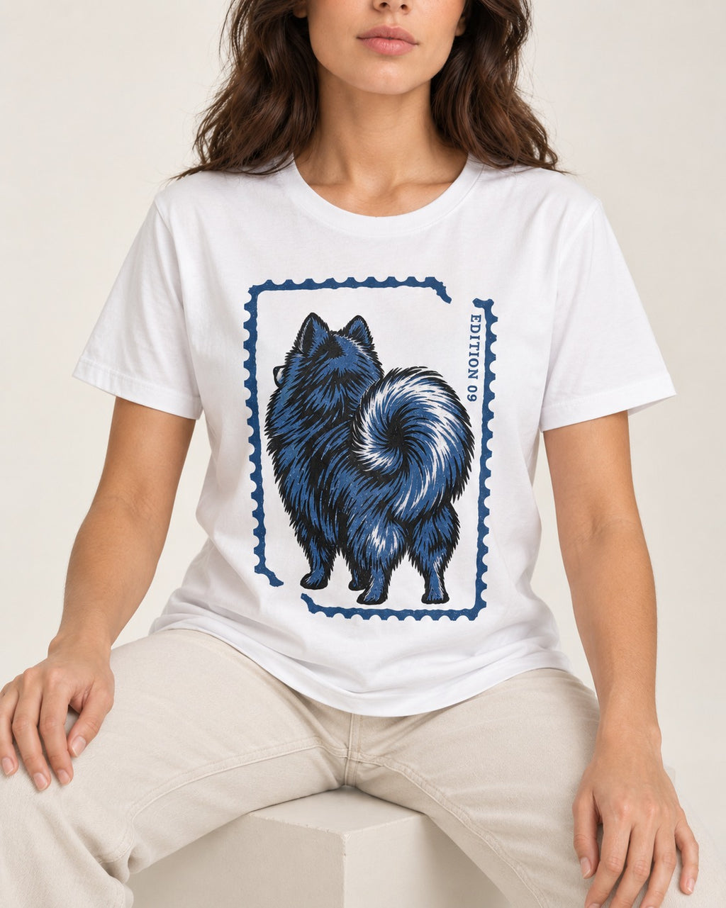 Pomeranian Pride T-Shirt in White, worn by a seated model
