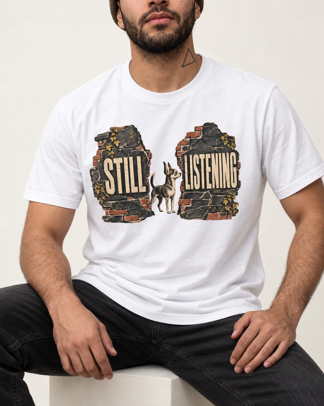 Chihuahua Still Listening T-Shirt in White, worn by a seated model