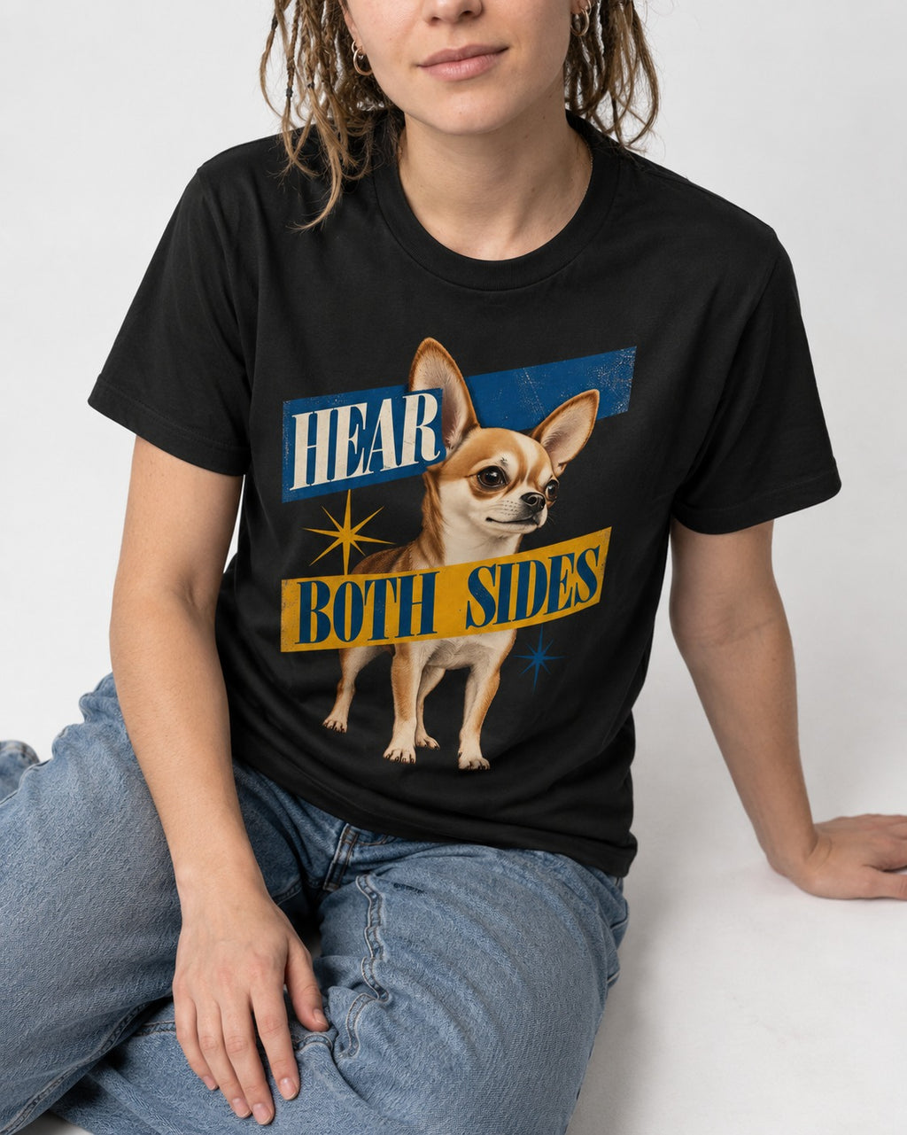 Chihuahua Hear Both Sides Banner Graphic T-Shirt in Black, worn by a seated model