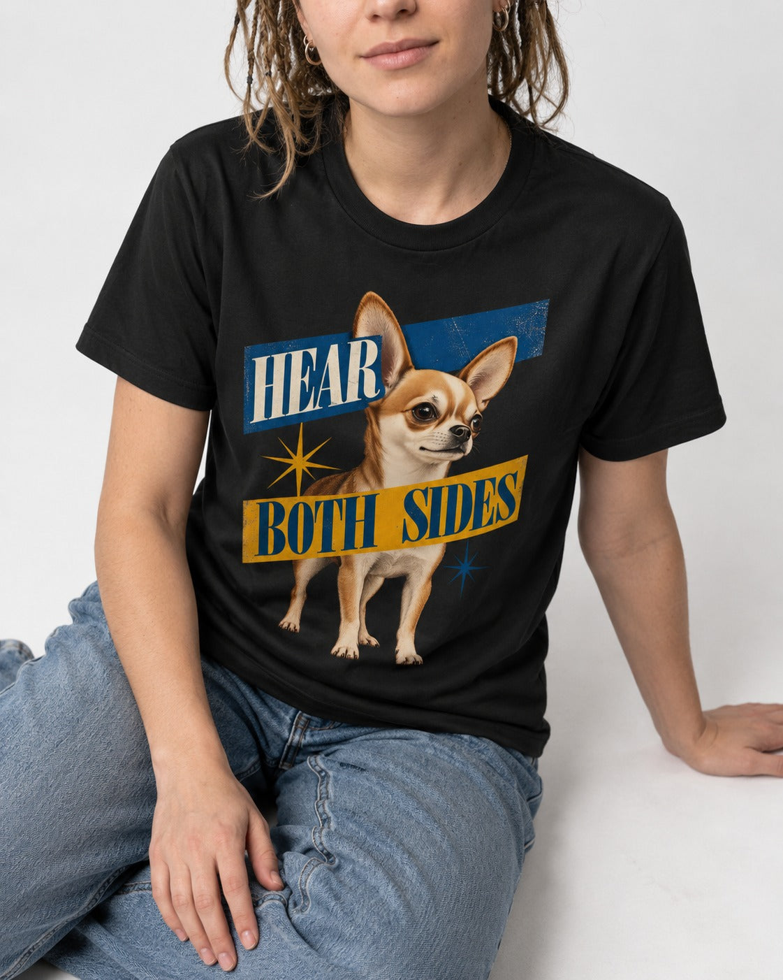 Chihuahua Hear Both Sides Banner Graphic T-Shirt in Black, worn by a seated model