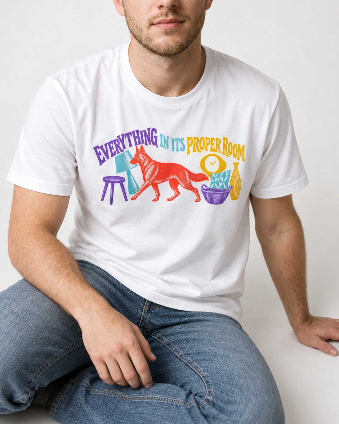 German Shepherd Dog In Its Proper Room T-Shirt in White, worn by a seated model