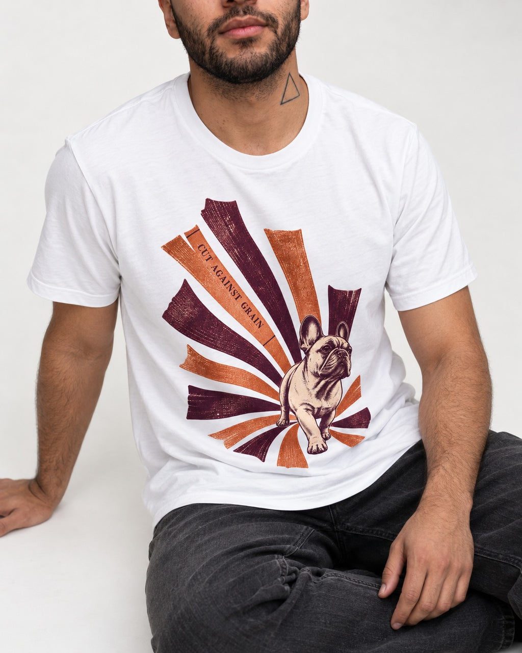 Frenchie Against the Grain T-Shirt in White, worn by a seated model