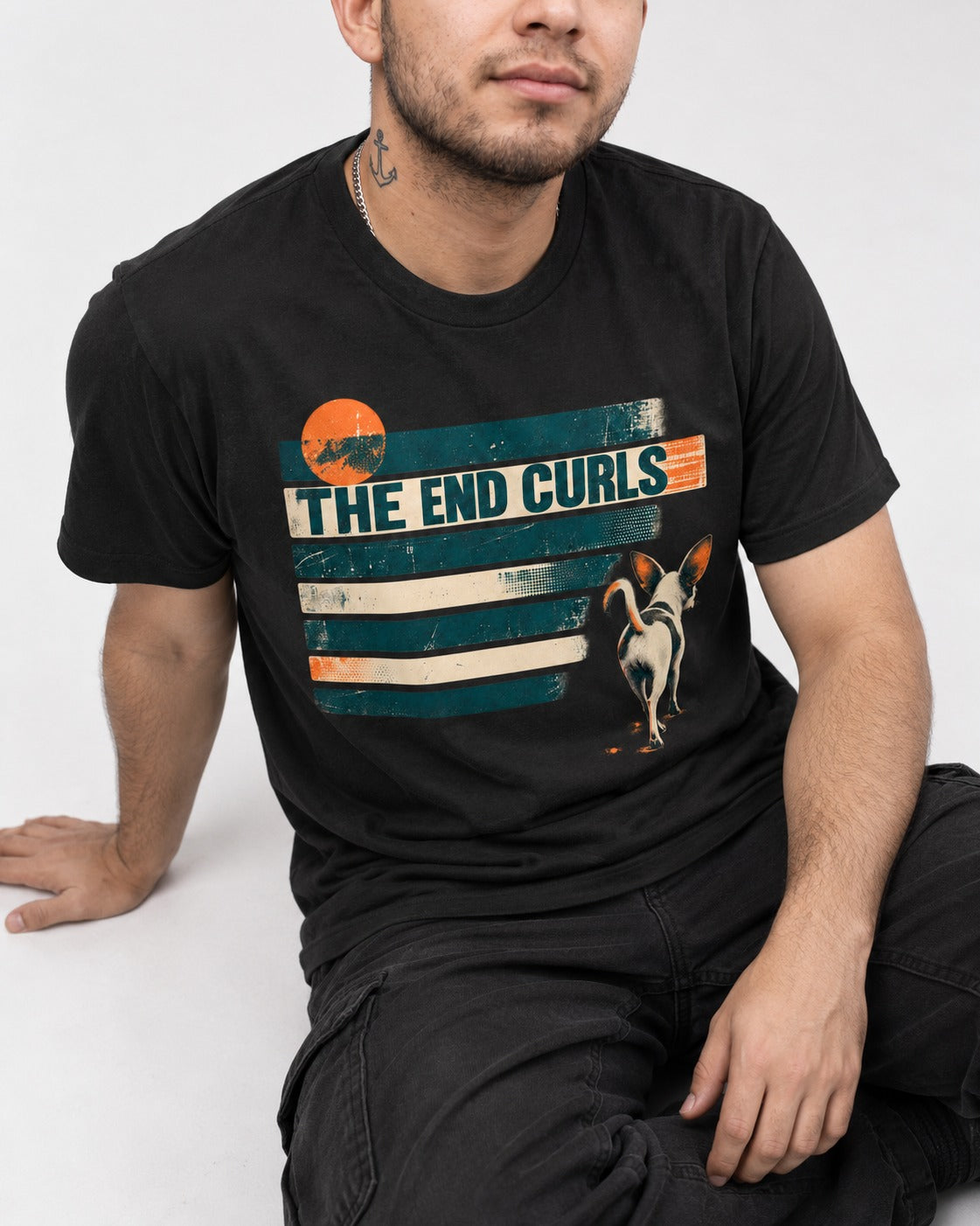 Chihuahua The End Curls Retro Stripe Graphic T-Shirt in Black, worn by a seated model