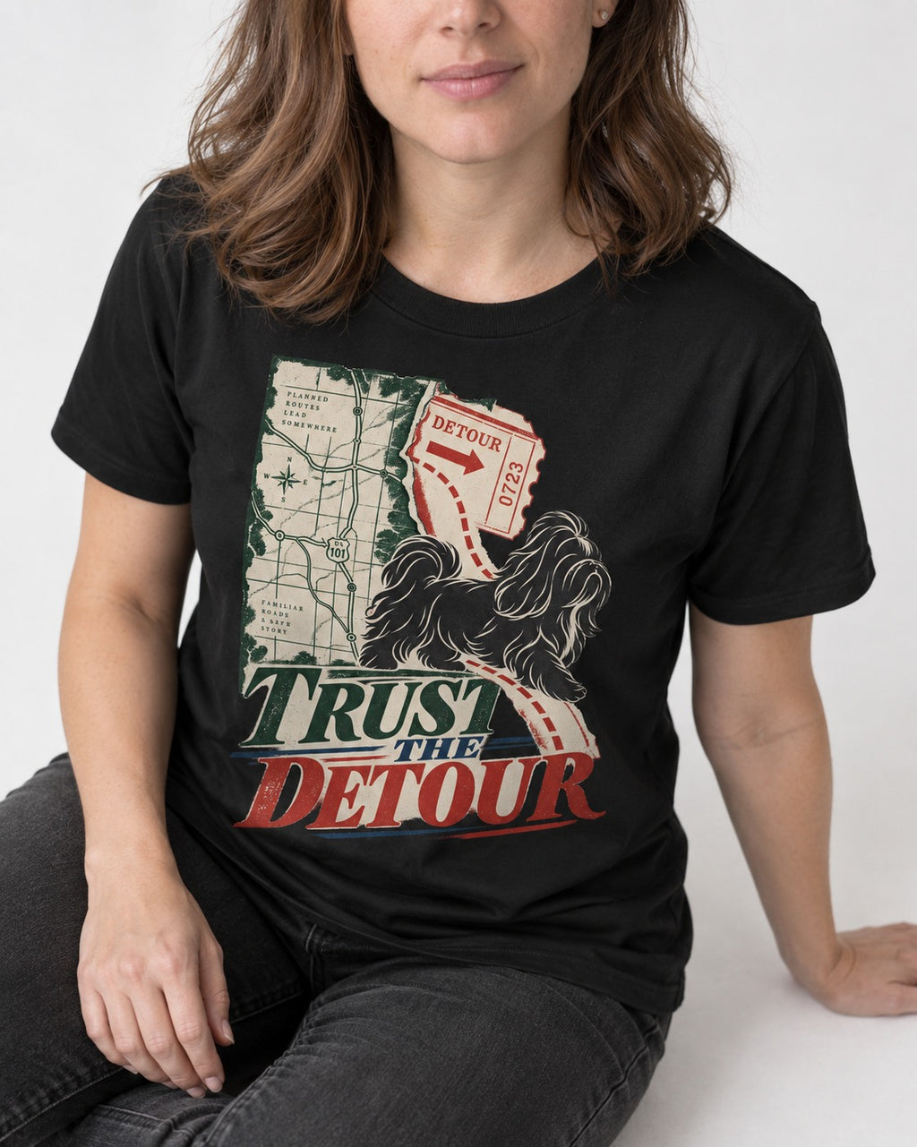 Shih Tzu Trust the Detour Road Map Graphic T-Shirt in Black, worn by a seated model