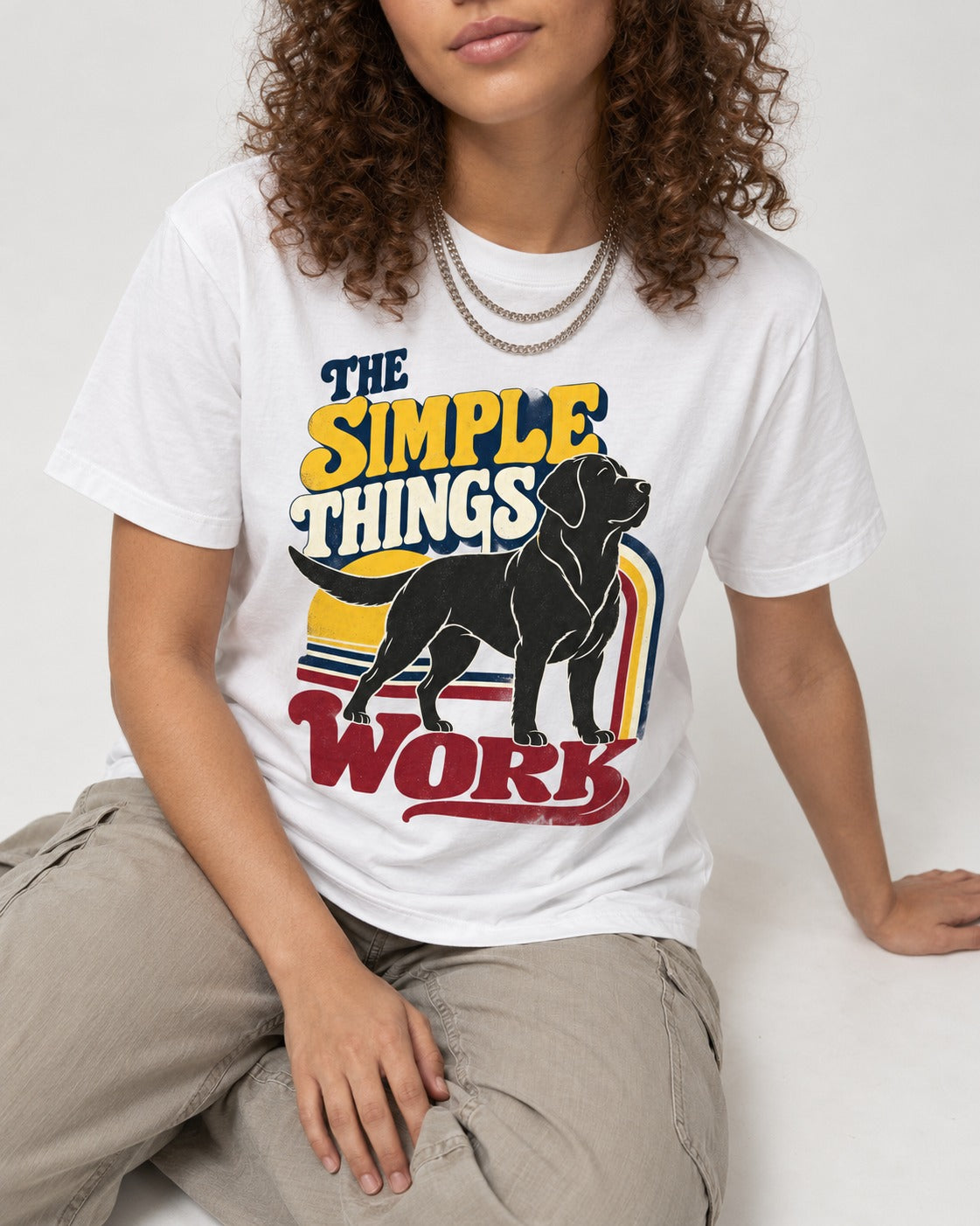 The Simple Things Work Labrador Retriever T-Shirt in White, worn by a seated model