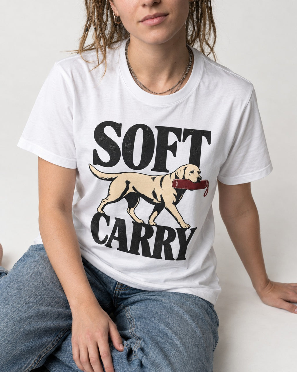 Soft Carry Labrador Retriever T-Shirt in White, worn by a seated model