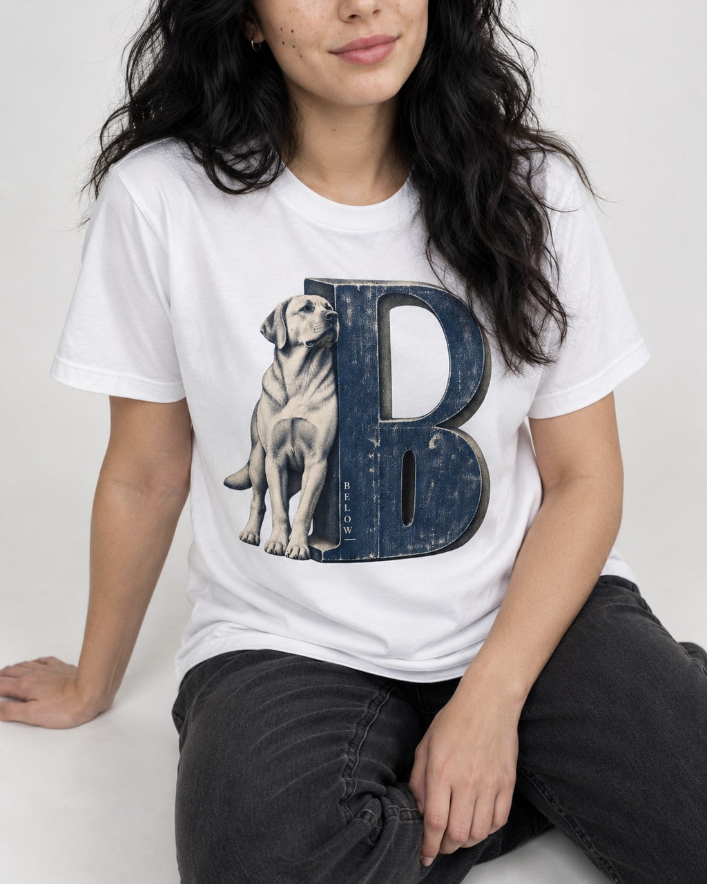 Labrador Retriever Below T-Shirt in White, worn by a seated model