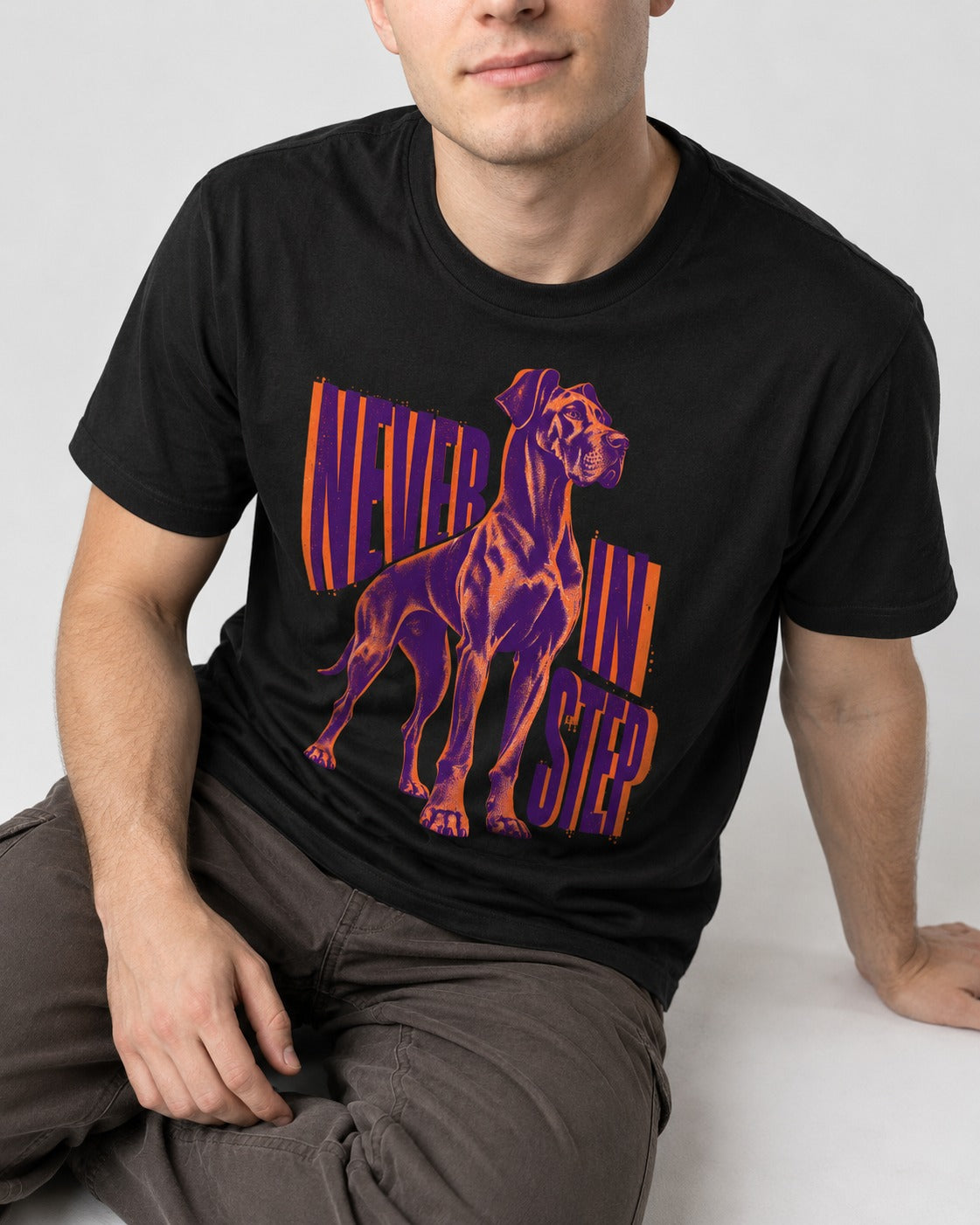 Great Dane Never in Step Standing Graphic T-Shirt in Black, worn by a seated model