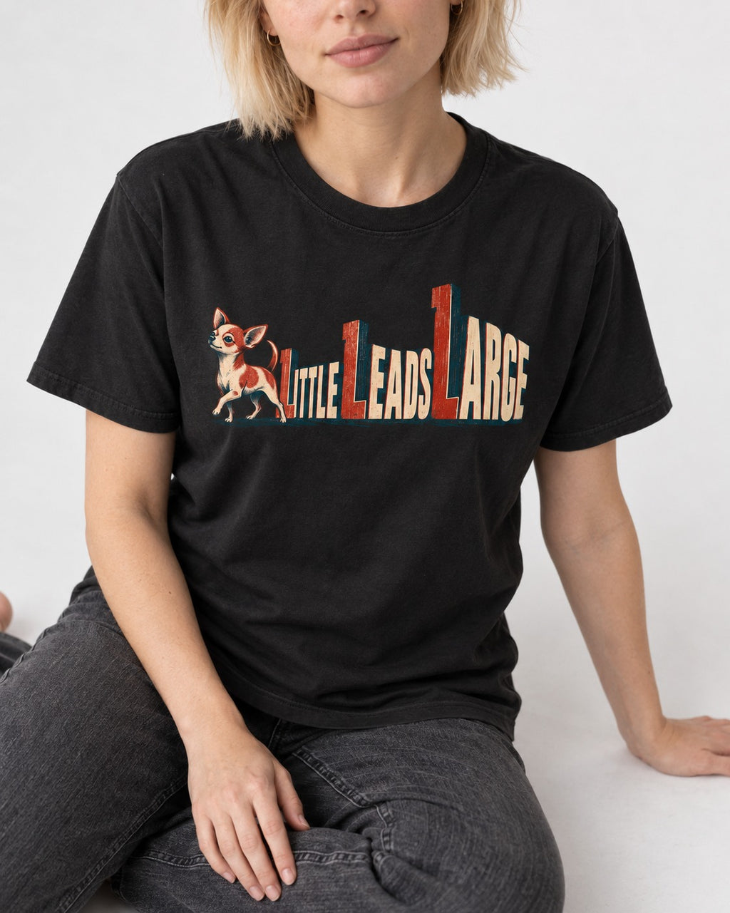 Chihuahua Little Leads Large Perspective Typography T-Shirt in Black, worn by a seated model
