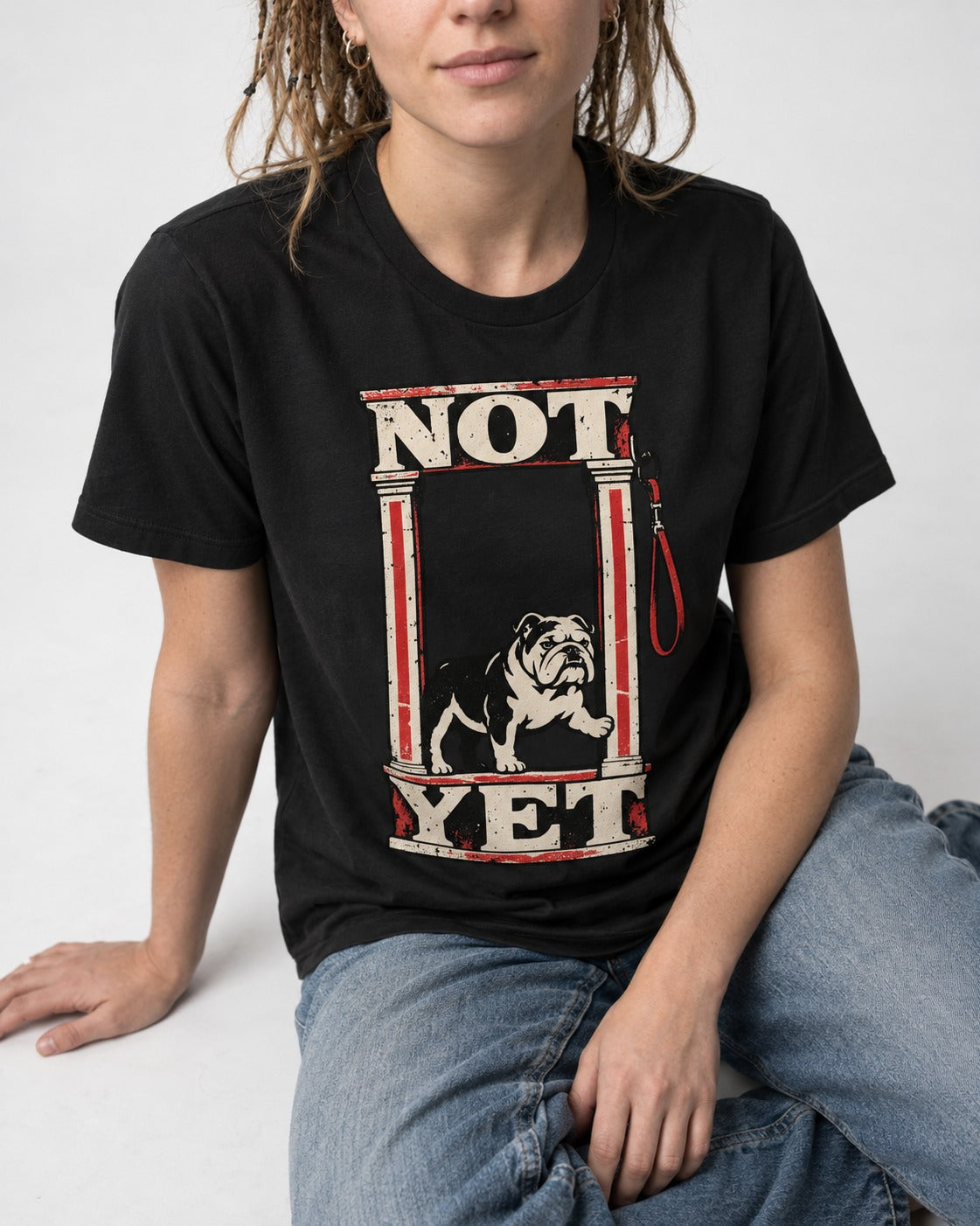 English Bulldog Not Yet Doorway Graphic T-Shirt in Black, worn by a seated model