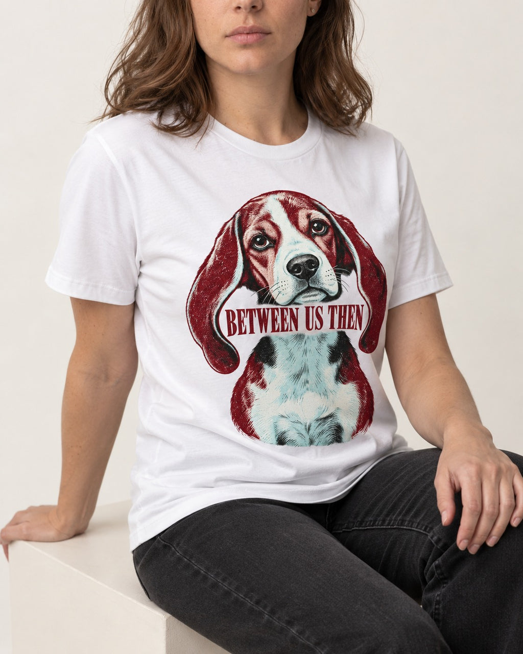 Beagle Between Us Then T-Shirt in White, worn by a seated model