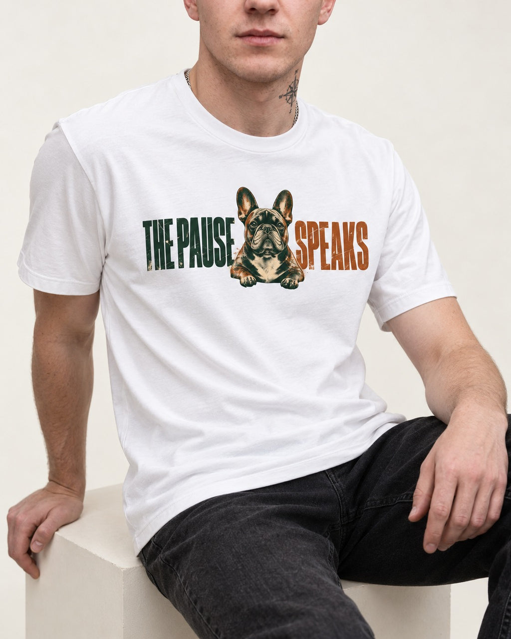 The Frenchie Pause Speaks T-Shirt in White, worn by a seated model