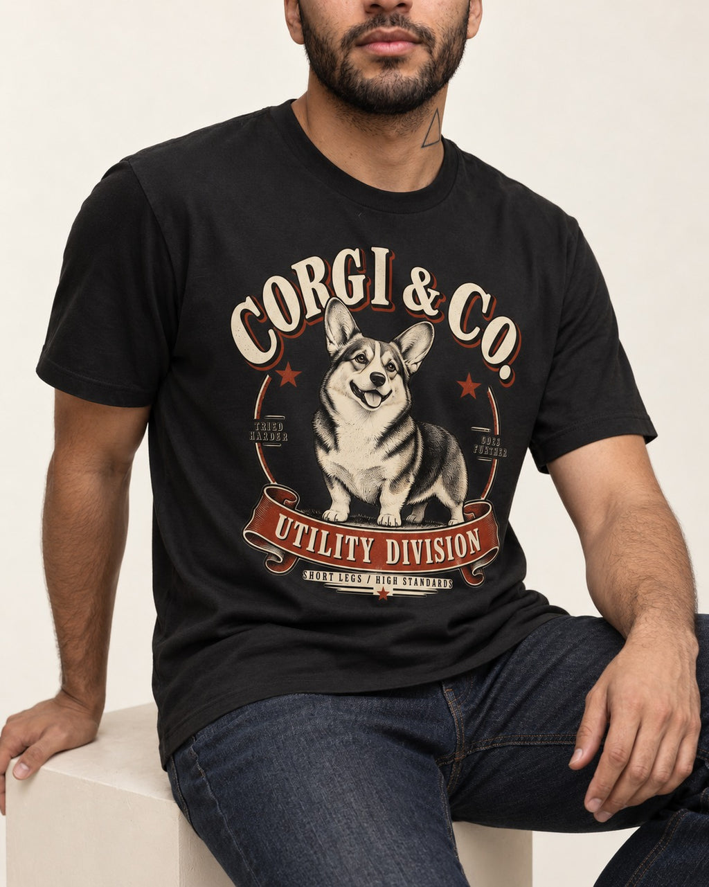Corgi's High Standards T-Shirt in Black, worn by a seated model