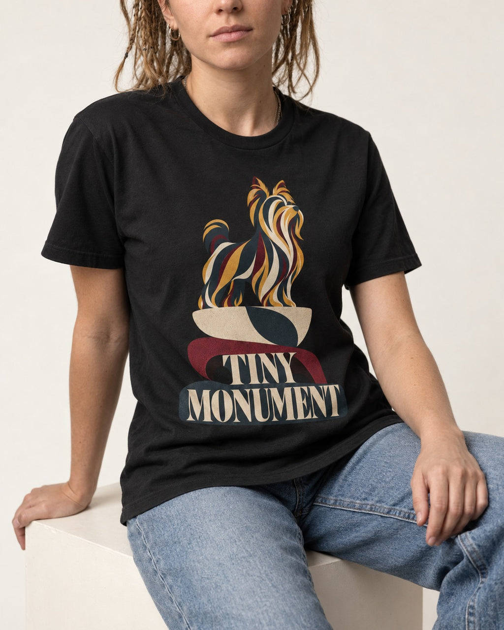 Yorkshire Terrier Tiny Monument Sculptural Plinth Graphic T-Shirt in Black, worn by a seated model
