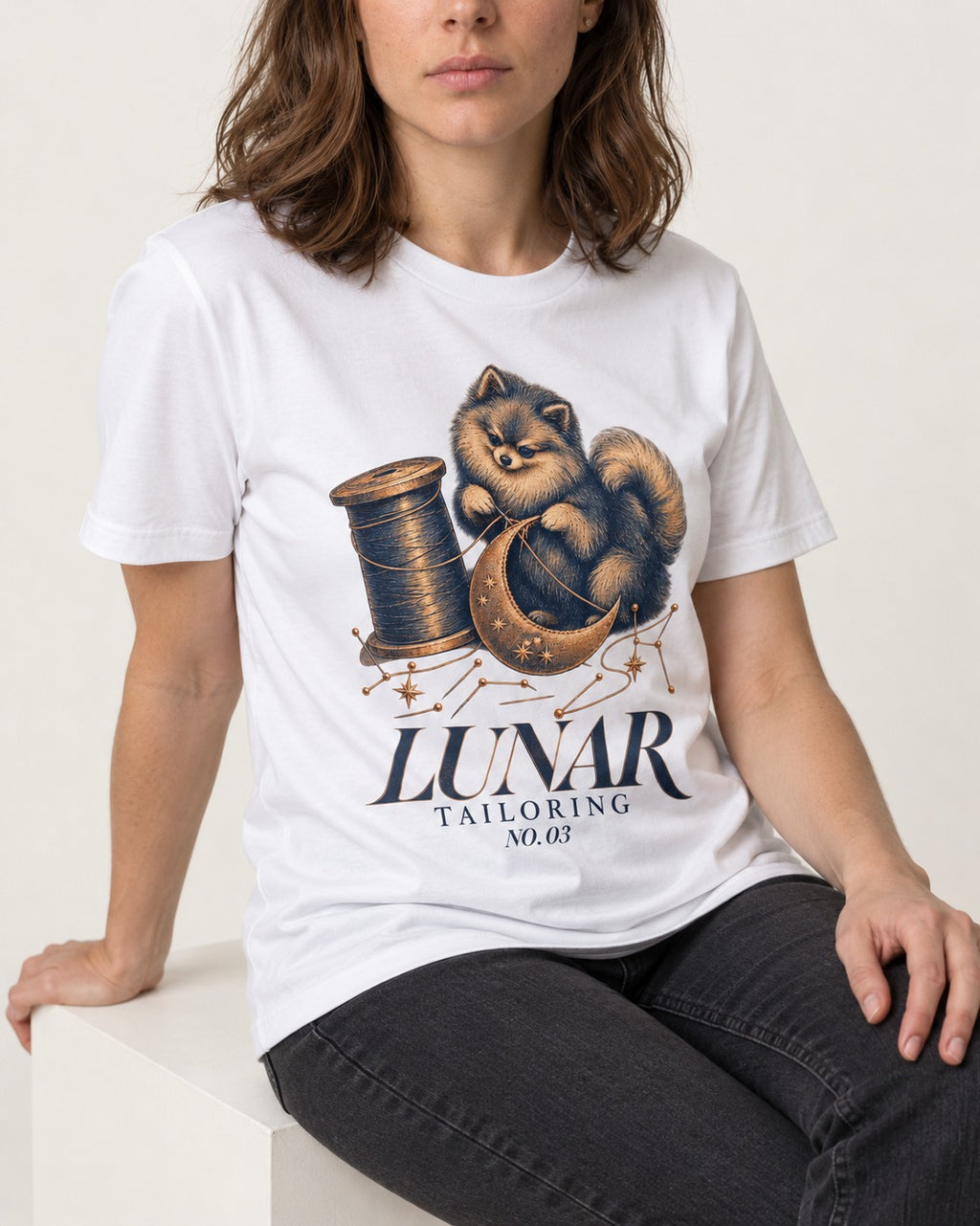 Pomeranian's Lunar Tailoring T-Shirt in White, worn by a seated model